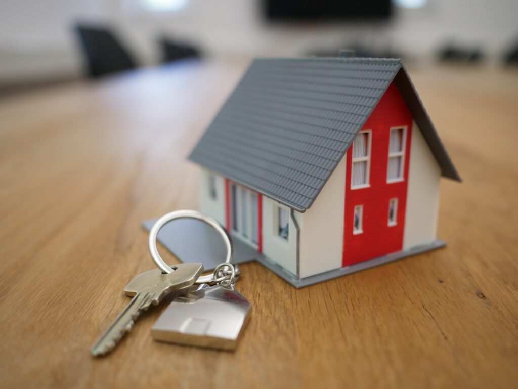 A miniature house with a set of keys.